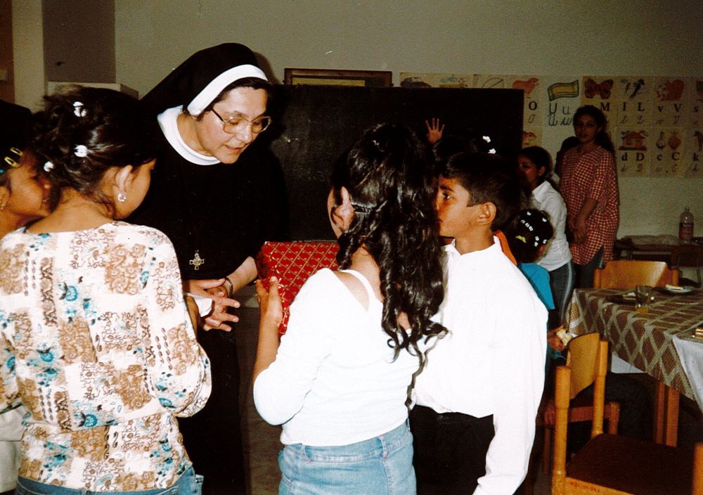 Romani children in Bardejov, Slovakia,thank Sr. Atanazia Holubova after their first Communion. (Courtesy of Emanujila Vishka)