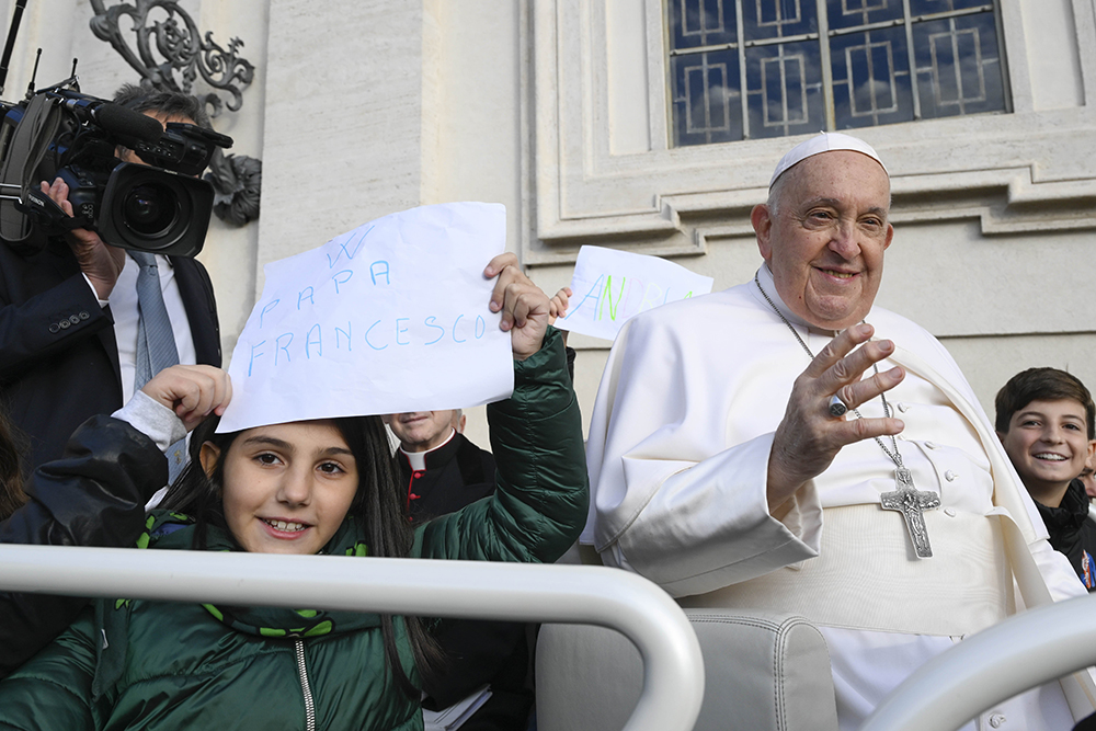 Children ride with Pope Francis in the popemobile during the pope's general audience in St. Peter's Square at the Vatican Nov. 22. (CNS/Vatican Media)