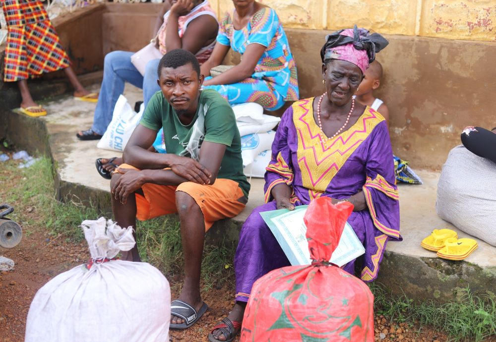 Residents of Makeni, a town in northern Sierra Leone, receive food aid from religious sisters on Sept. 20. Since the end of the Ebola epidemic in 2015, religious sisters in Sierra Leone have been providing food to Ebola survivors and presenting awareness sessions to help survivors reintegrate into their communities. (GSR Photo/Doreen Ajiambo)