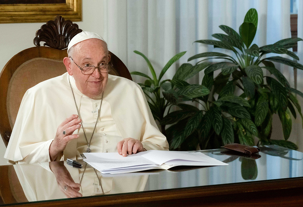 Pope Francis smiles after delivering his speech by video from the Vatican to religious leaders attending the inauguration of the Faith Pavilion at the U.N. climate change conference Dec. 3 in Dubai, United Arab Emirates. Pope Francis canceled his trip to Dubai because of a bronchial infection. (CNS/Vatican Media)