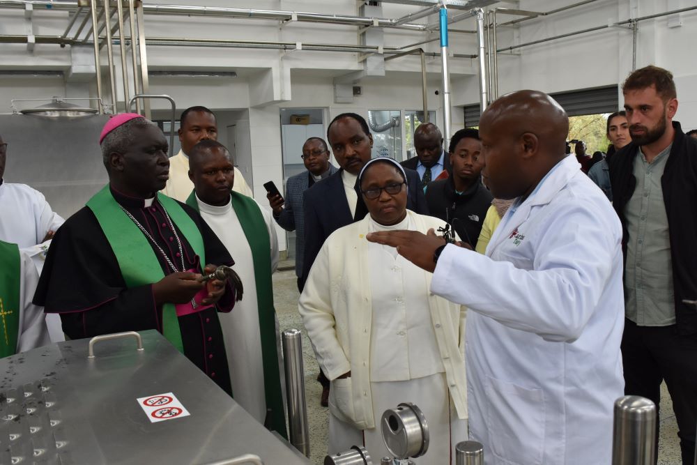 Archbishop Philip Arnold Subira Anyolo of Nairobi, Kenya, is pictured listening to Michael Kiburi, acting CEO of Caritas Dairy and the deputy director of programs, Caritas Nairobi, during the opening of a milk processing plant in Nairobi on Nov. 16, 2023. (OSV News photo/courtesy Caritas Nairobi)