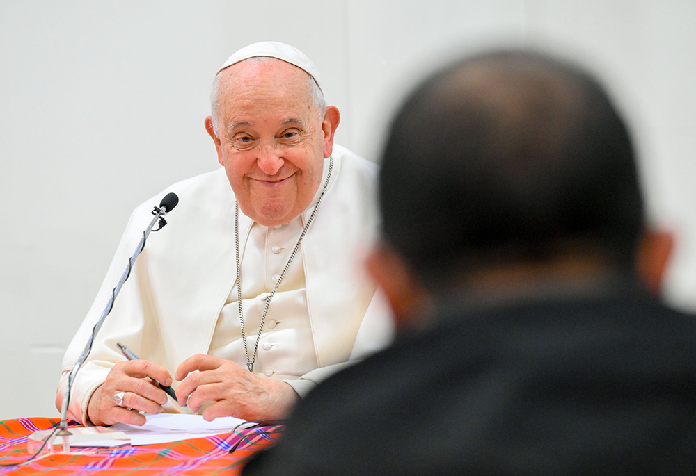 Pope Francis smiles as he meets with some 30 priests — Canossian Fathers and priests from the Diocese of Rome — in the pastoral center of St. George of Acilia Parish in south Rome Dec. 21, 2023. (CNS/Vatican Media)