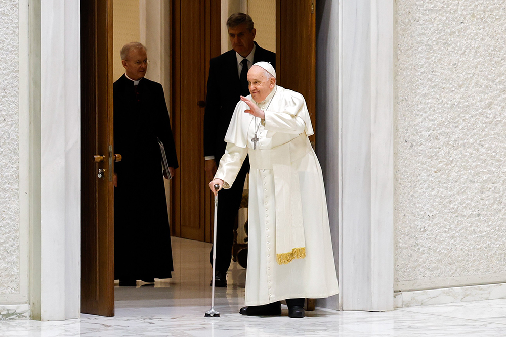 Pope Francis, walking with a cane, arrives in the Paul VI Audience Hall for his weekly general audience at the Vatican Dec. 27. (CNS/Lola Gomez)