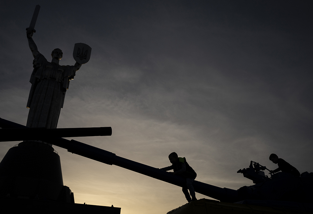 Children play on top of tanks on display in front of the Motherland Monument Oct. 31 in Kyiv, Ukraine. (AP photo/Bram Janssen)