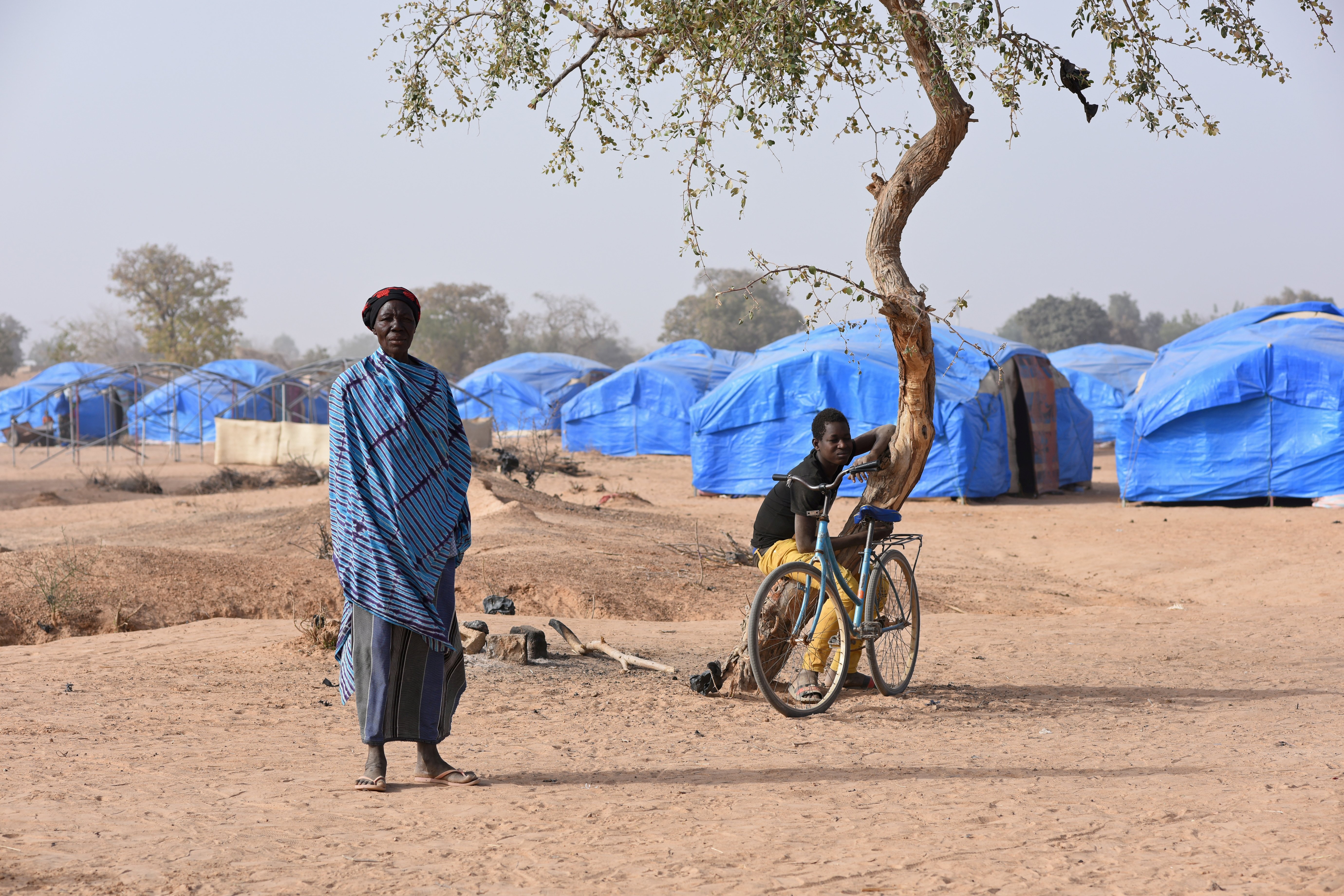 A displaced woman and young man are seen at a camp Jan. 24, 2020, in Pissila, Burkina Faso. The Famine Early Warning Systems Network predicts that by July, parts of Burkina Faso, Ethiopia, Yemen, Sudan, South Sudan, Somalia, Haiti, Mali and Nigeria will be at internationally recognized emergency levels of food insecurity. (CNS/Reuters/Anne Mimault)