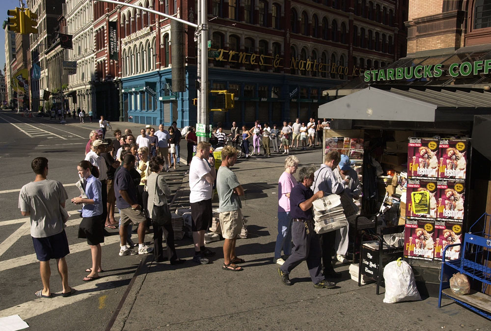 People line up to buy newspapers on Sept. 12, 2001, after the Sept. 11 terrorist attacks on the World Trade Center in New York City. (AP/Chad Rachman)