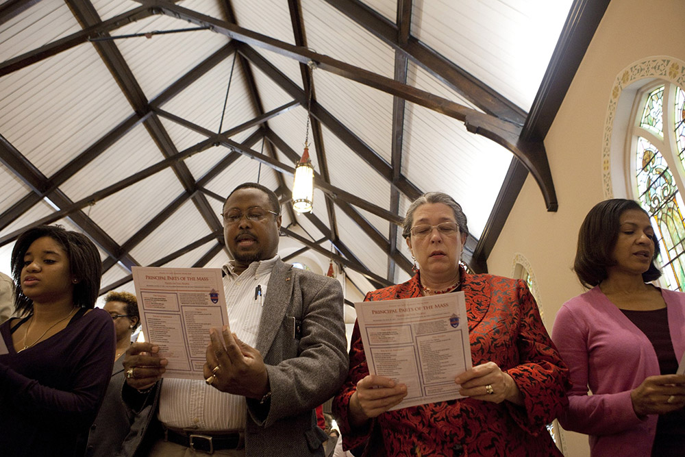 Parishioners use Mass guides during a Sunday morning service at St. Joseph's Catholic Church in Alexandria, Virginia, Nov. 27, 2011. That year, the 2010 English translation of the Roman Missal was used for the first time in churches across the nation on the first Sunday of Advent. (CNS/Nancy Phelan Wiechec)