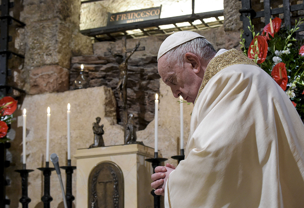 Pope Francis celebrates Mass at the tomb of St. Francis in the crypt of the Basilica of St. Francis Oct. 3, 2020, in Assisi, Italy. The pope signed his encyclical "Fratelli Tutti" at the end of the Mass. Francis makes "A Better Kind of Politics" the subject of an entire chapter. (CNS/Vatican Media)