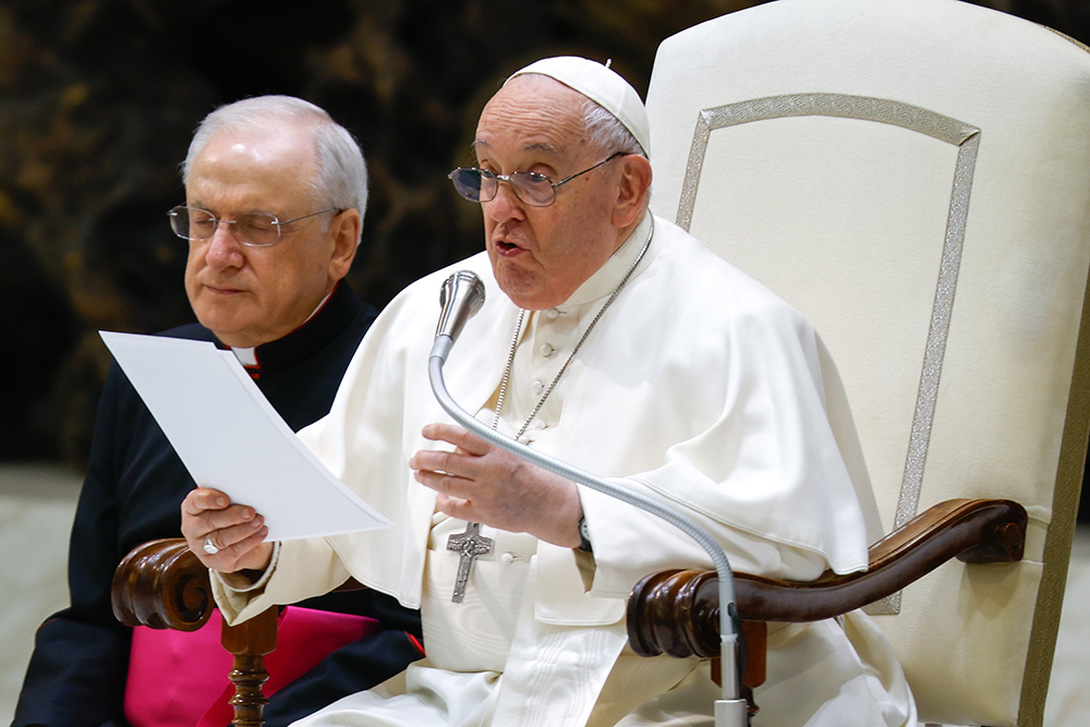 Pope Francis talks to visitors during his weekly general audience in the Paul VI Audience Hall at the Vatican Feb. 14, 2024. (CNS/Lola Gomez)