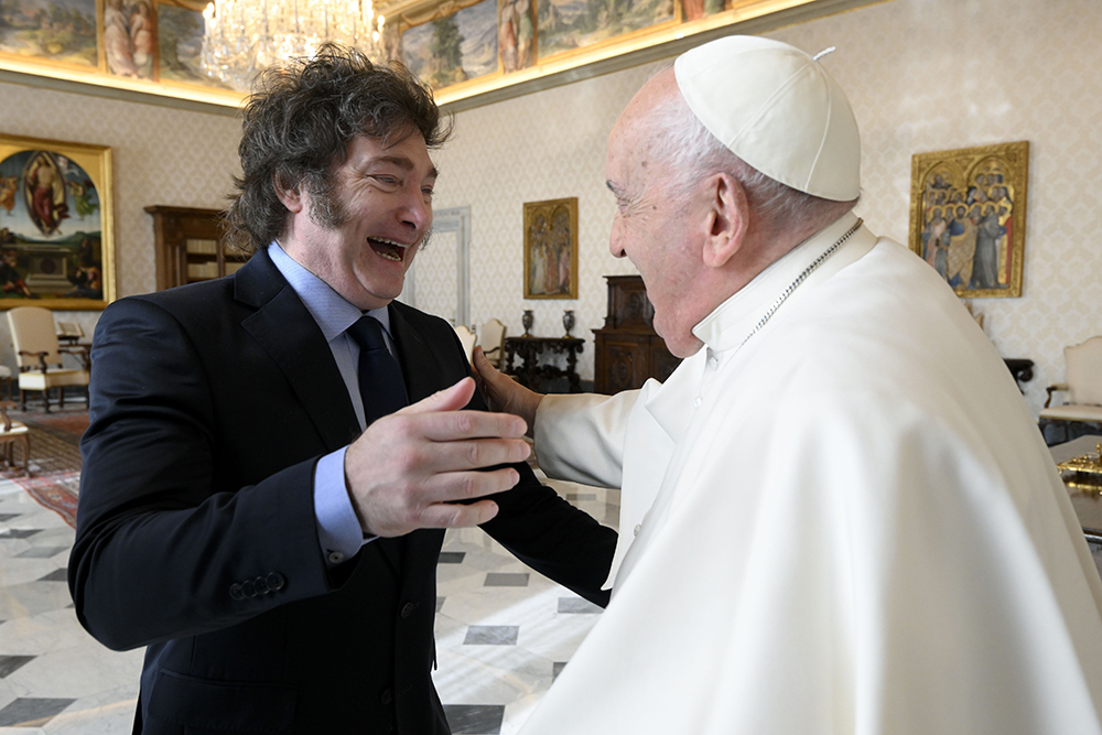 In this image distributed by Vatican Media, Argentine President Javier Milei, left, cheers at Pope Francis as they meet in the pontiff's studio at The Vatican for a private audience Feb. 12, 2024. (Vatican Media via AP, HO)