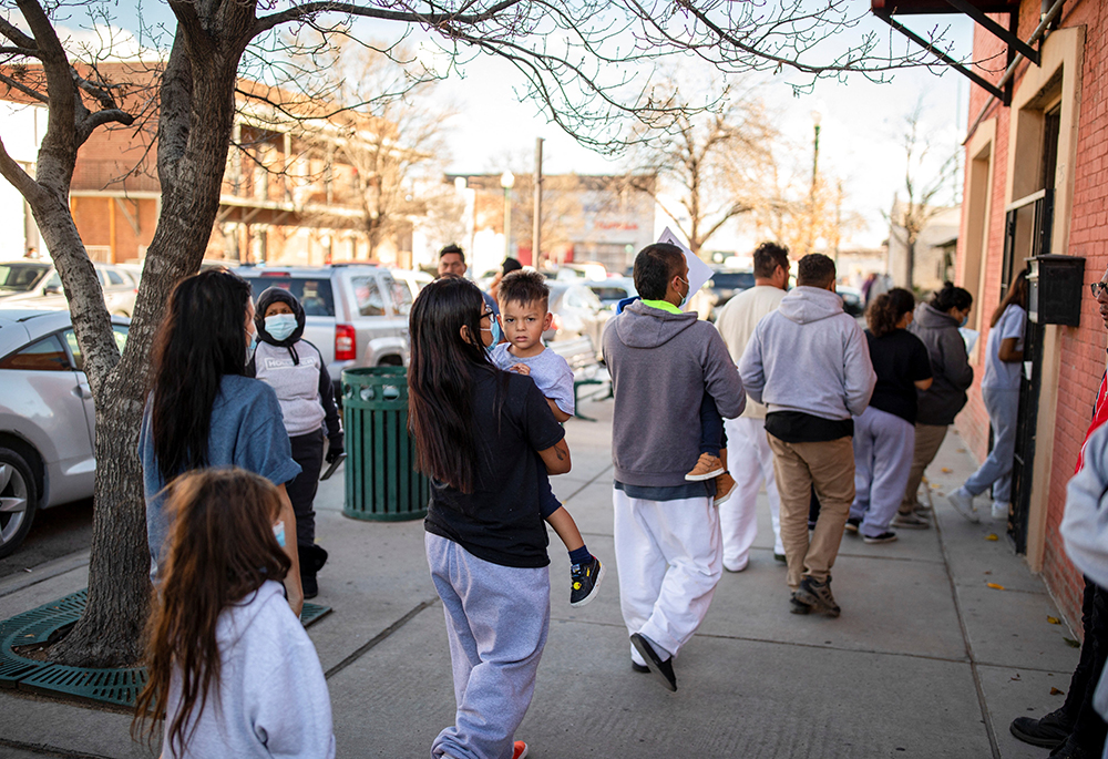 A family of migrants is dropped off by a transport contractor for the U.S. Customs and Border Protection at a shelter run by Annunciation House Dec. 13, 2022, in downtown El Paso, Texas. A state judge blocked the Texas attorney general's demands for the records of Annunciation House March 11, 2024, citing concerns the state had a "predetermined" motive to shut down the Catholic nonprofit serving migrants. (OSV News/Reuters/Ivan Pierre Aguirre)