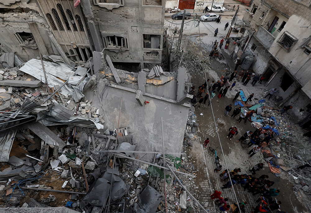  Palestinians inspect the site of Israeli airstrike on a house, amid the ongoing conflict between Israel and the Palestinian Islamist group Hamas, in Rafah, in the southern Gaza Strip, on March 24. (OSV News/Reuters/Mohammed Salem)