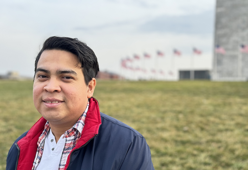 Miguel Flores, one of the 222 Nicaraguan political prisoners sent on a plane to Washington last year, poses for a photo near the Washington Monument on Feb. 22. He said he is determined to keep fighting for democracy and "can't look the other way" when it comes to the abuses in Nicaragua. (NCR photo/Rhina Guidos) 