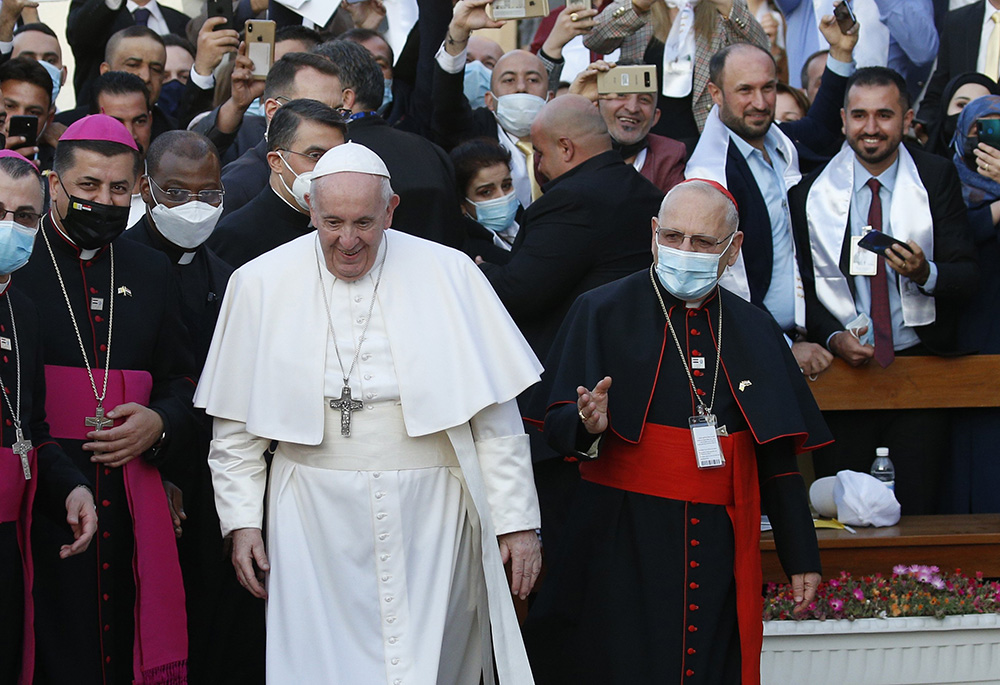 Pope Francis walks next to Chaldean Patriarch Louis Sako of Baghdad, right, as he arrives to celebrate Mass at the Chaldean Catholic Cathedral of St. Joseph in Baghdad March 6, 2021. (CNS/Paul Haring)