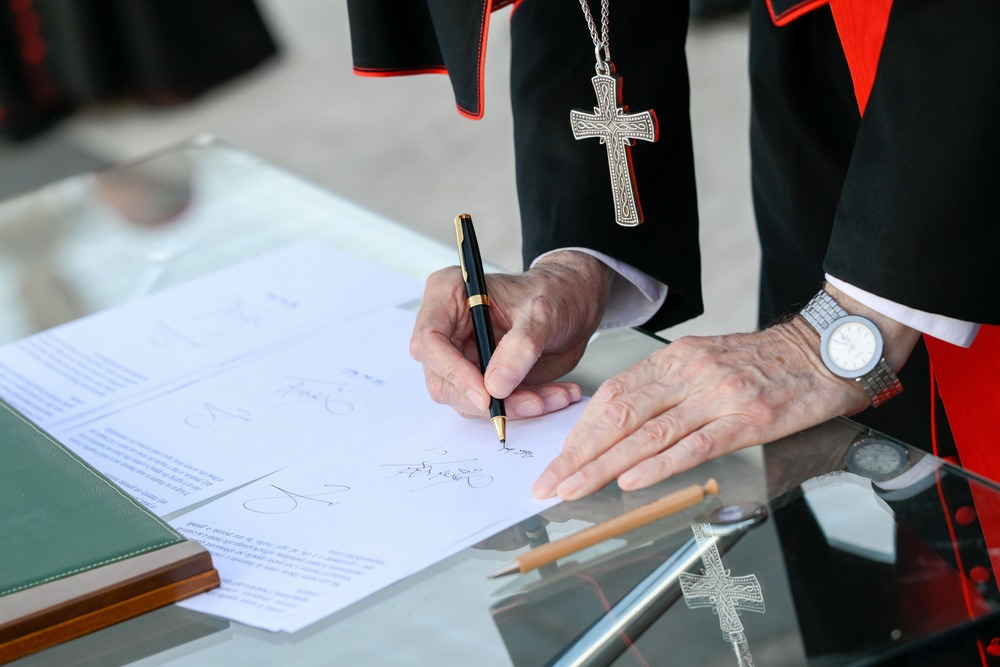 Cardinals hands and pectoral cross visible