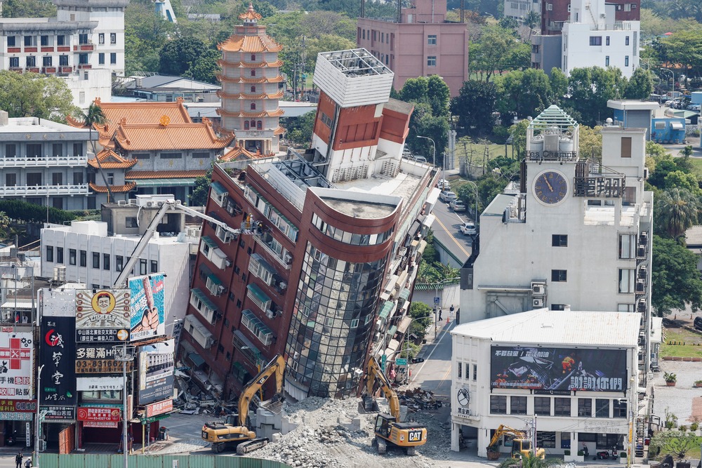 Collapsed buildings buckle towards street