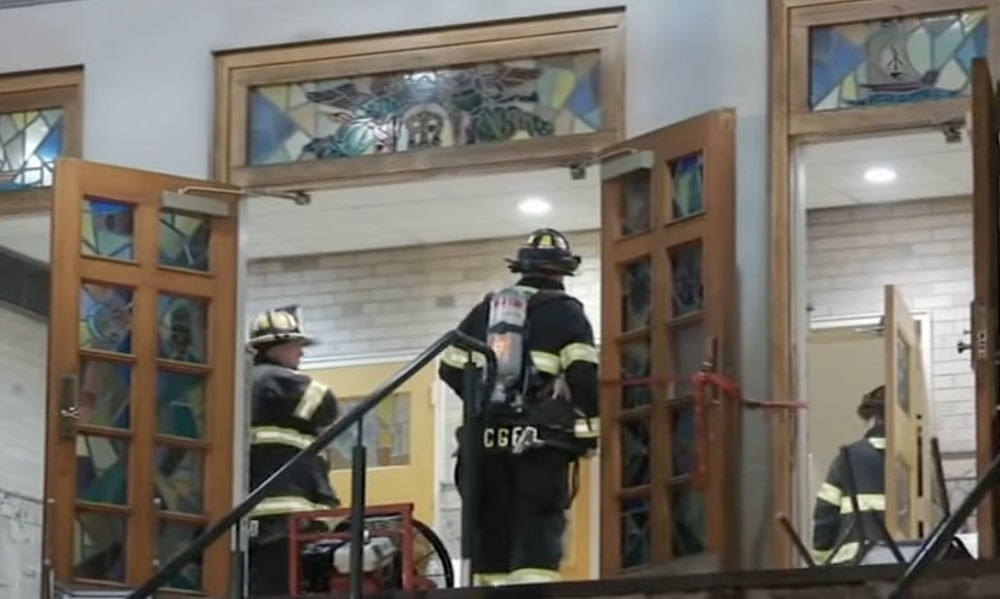 New Jersey church arson. Firefighters seen through open doors of church.