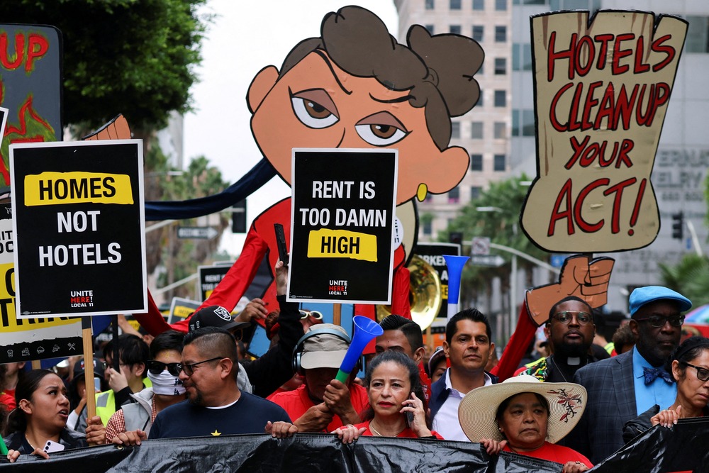 Strikers hold signs in street.