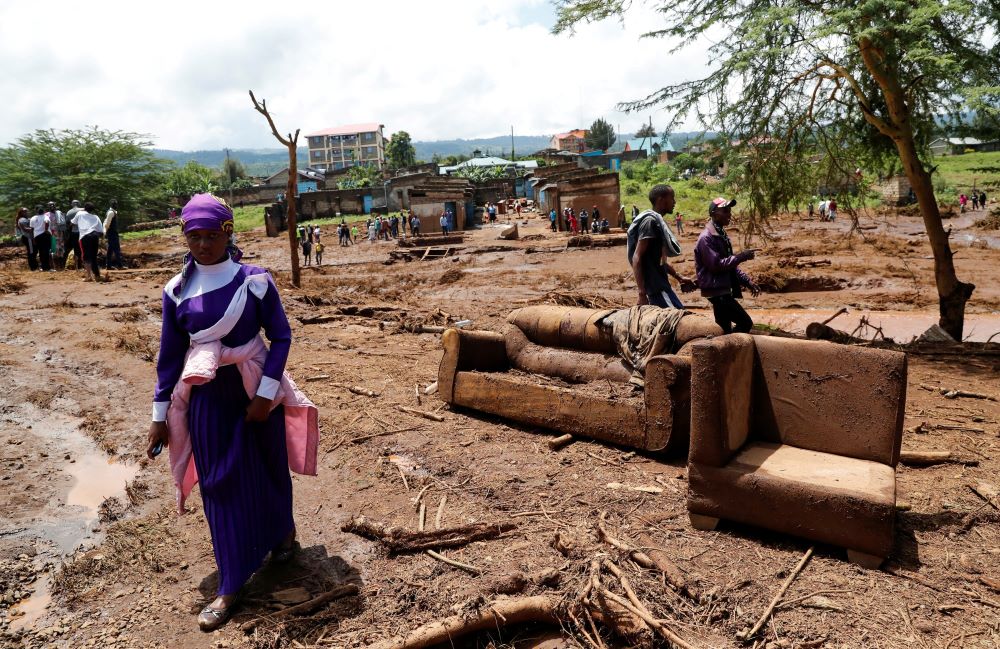 A woman walks past couches in the Kamuchiri village of Mai Mahiu in central Kenya's Nakuru County April 29, 2024, after heavy flash floods wiped out several homes when a dam burst, following heavy rains. (OSV News photo/Thomas Mukoya, Reuters)