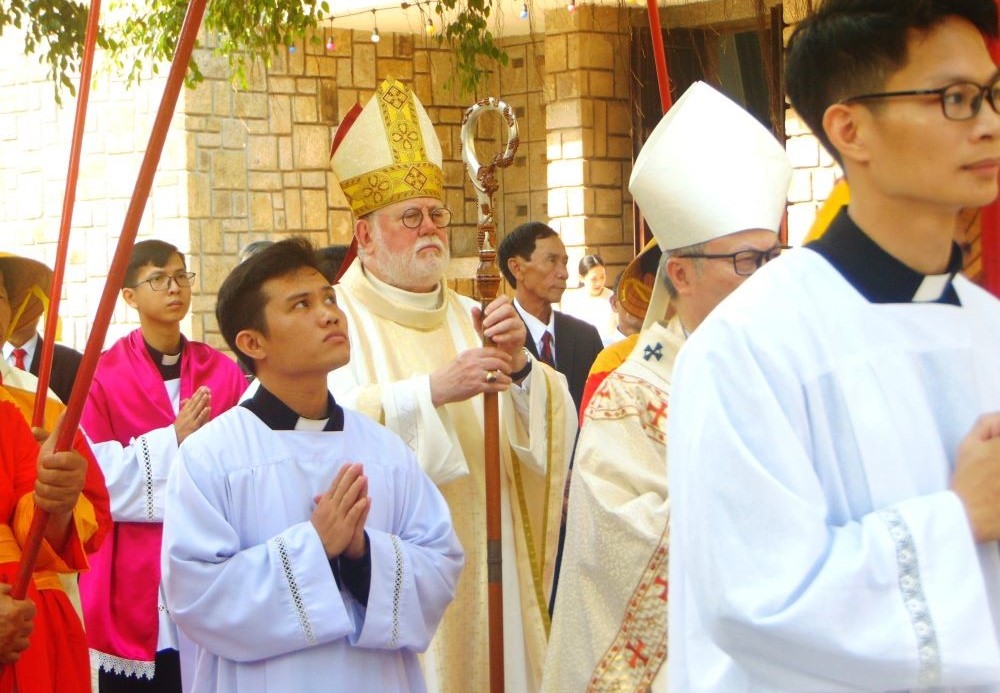 Archbishop Paul Gallagher, the Vatican's foreign minister, walks in a procession to enter Phu Cam Cathedral in Hue for a Mass on April 12. 