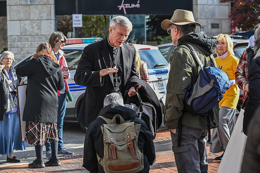 Bishop Joseph Strickland prays over an individual near the United States Conference of Catholic Bishops meeting in Baltimore Nov. 15, 2023. (RNS/Jack Jenkins)