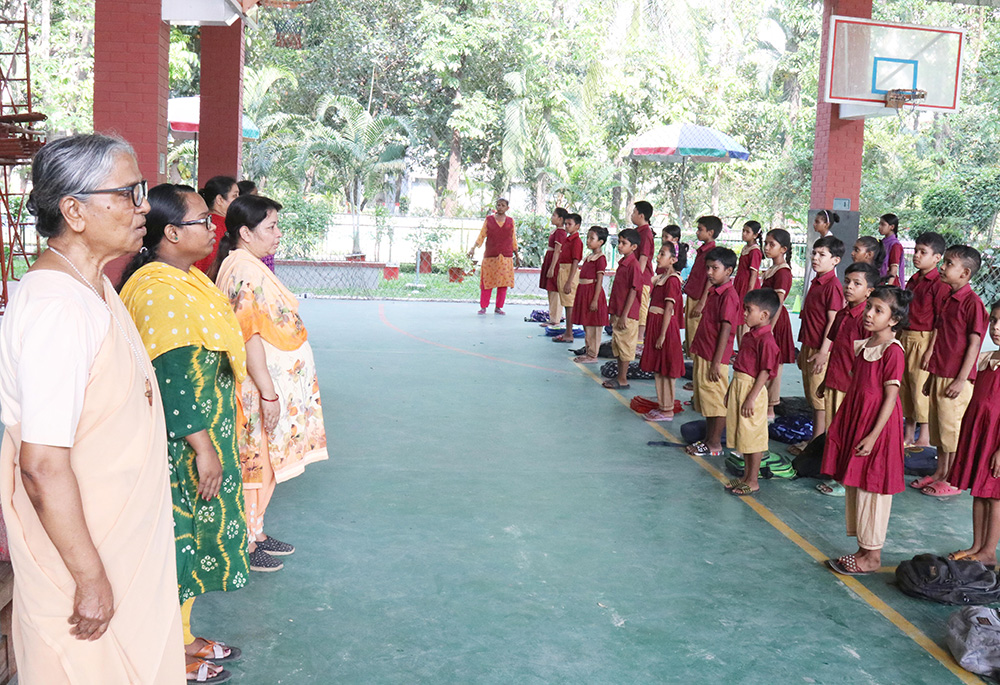 Teachers and students sing the national anthem of Bangladesh in the assembly before the start of class. (Stephan Uttom Rozario)