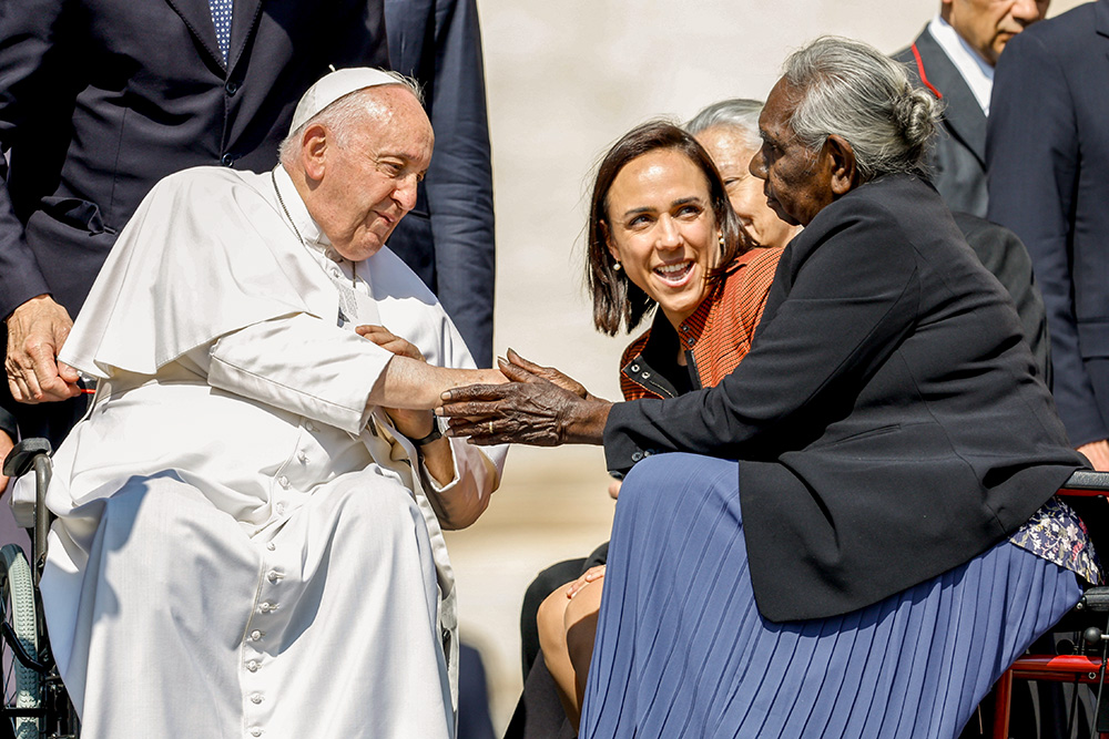 Pope Francis greets Miriam-Rose Ungunmerr Baumann, an Australian Aboriginal elder, educator and artist, after his weekly general audience May 31, 2023, in St. Peter's Square at the Vatican. Looking on is Chiara Porro, Australian ambassador to the Holy See. (CNS/Lola Gomez)