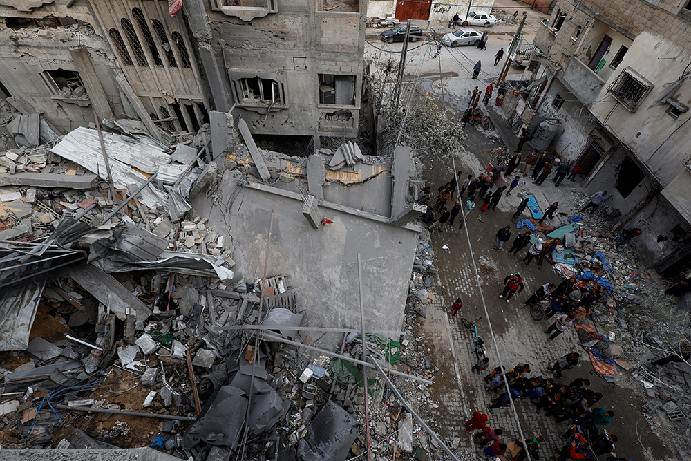 Palestinians inspect the site of Israeli airstrike on a house, amid the ongoing conflict between Israel and the Palestinian Islamist group Hamas, in Rafah, in the southern Gaza Strip, March 24, 2024. (OSV News/Reuters/Mohammed Salem)