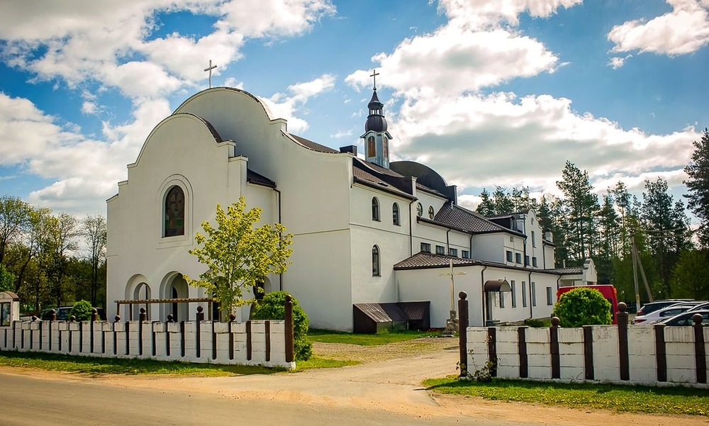 Church building pictured against bright blue sky. 