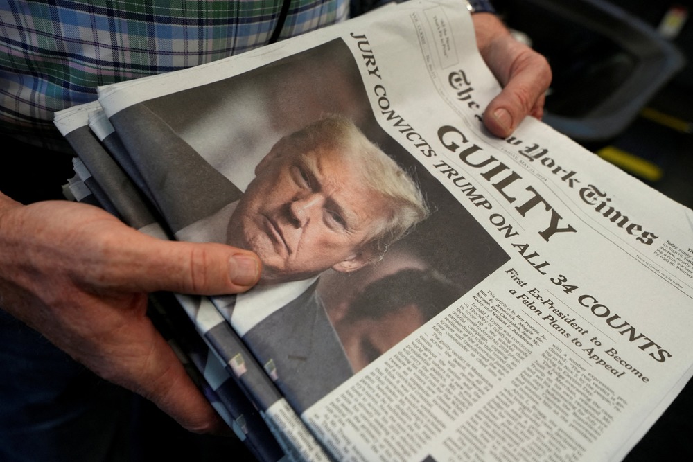 Stack of papers held in man's hands. 