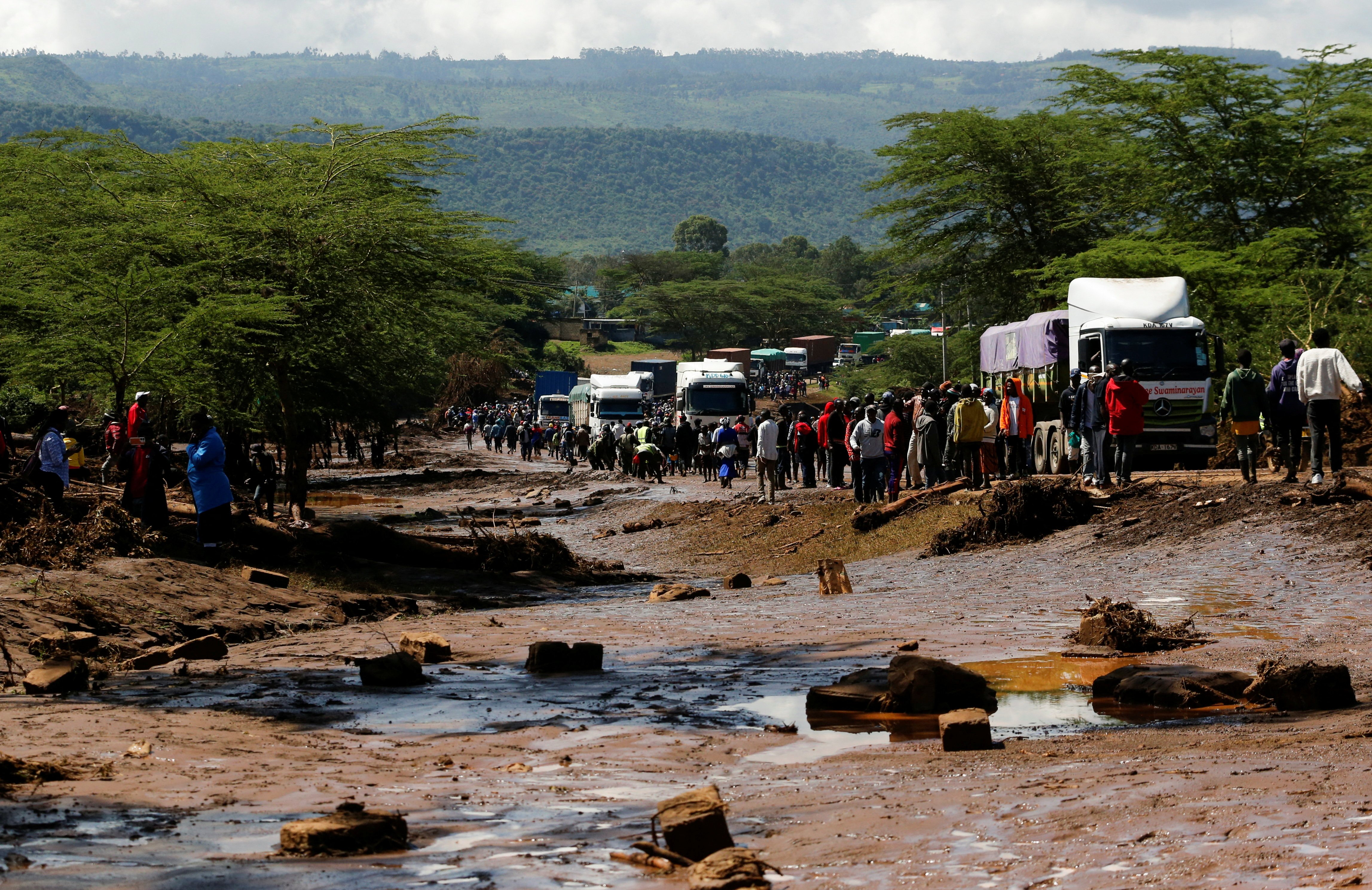 Residents and motorists walk along the Mai Mahiu-Naivasha highway in the Kamuchiri village of Mai Mahiu in central Kenya's Nakuru County April 29. 