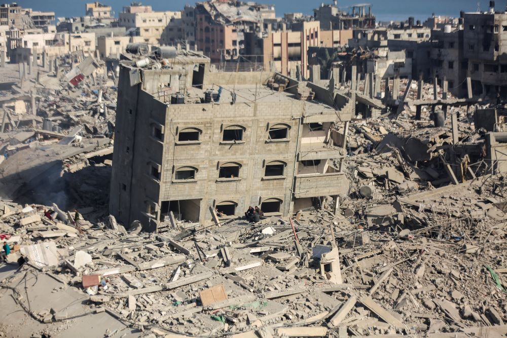 Palestinian men sit amid the rubble of destroyed houses and buildings at the area around Al Shifa Hospital amid the ongoing conflict between Israel and Hamas, in Gaza City April 1. 