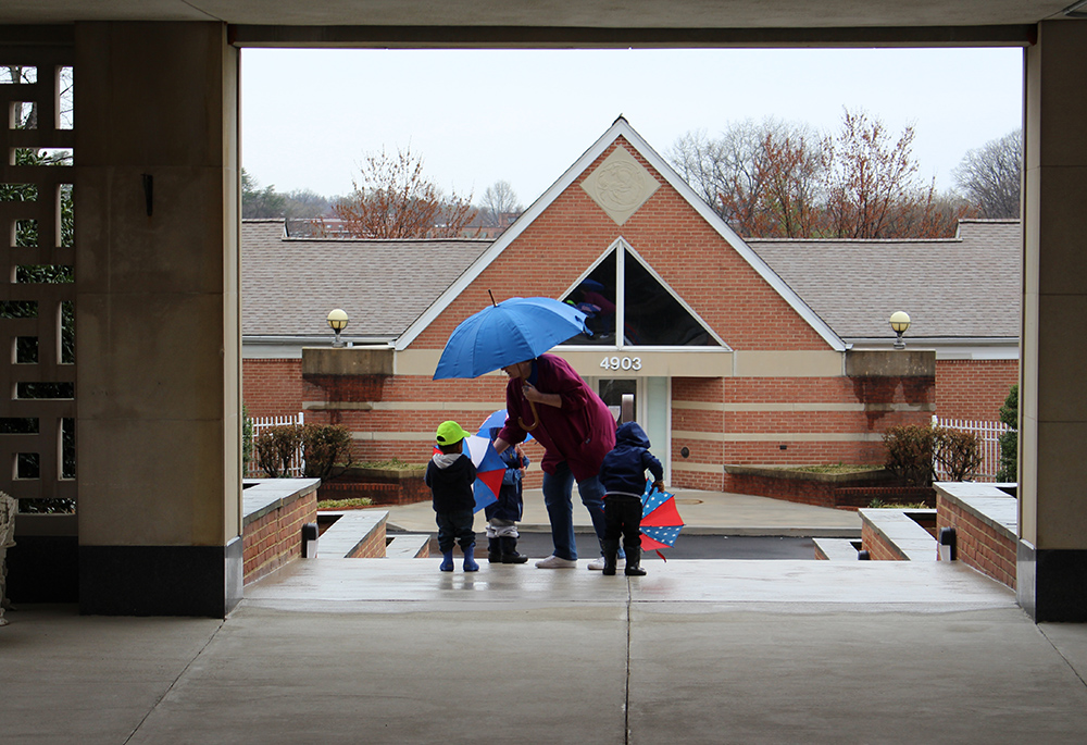 Children stand with a teacher of the child care program at St. Ann's Center for Children, Youth and Families. (Courtesy of St. Ann's Center for Children, Youth and Families)