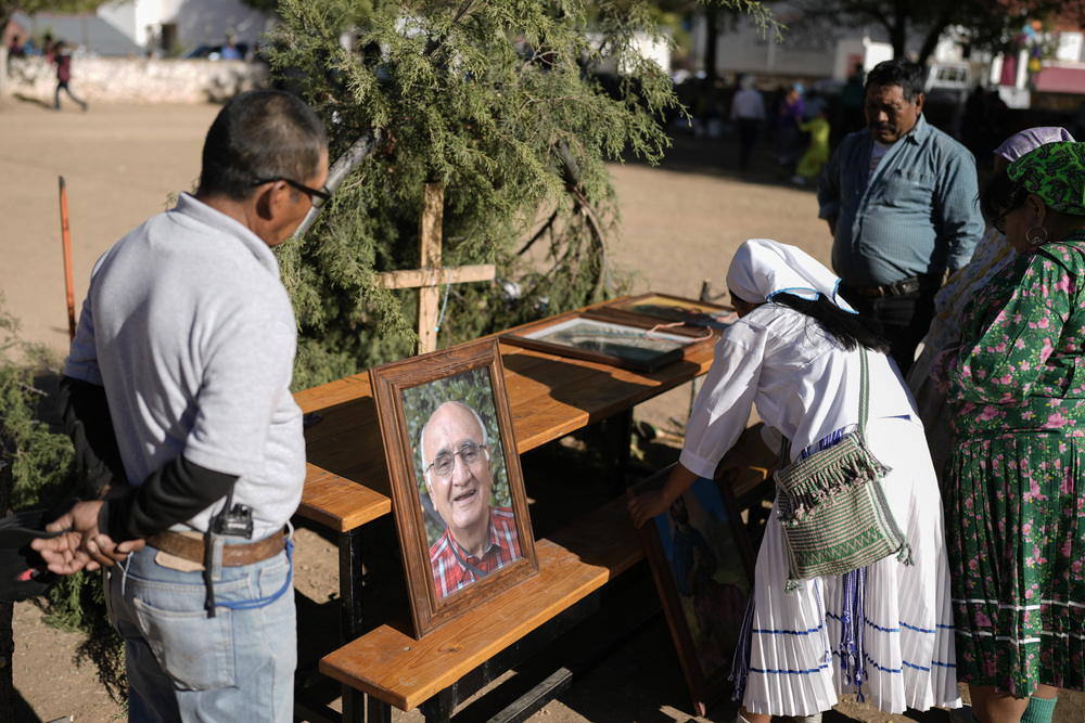 People gather around outdoor altar