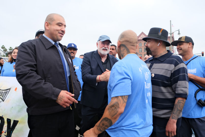 Boyle greets people in a crowd. 