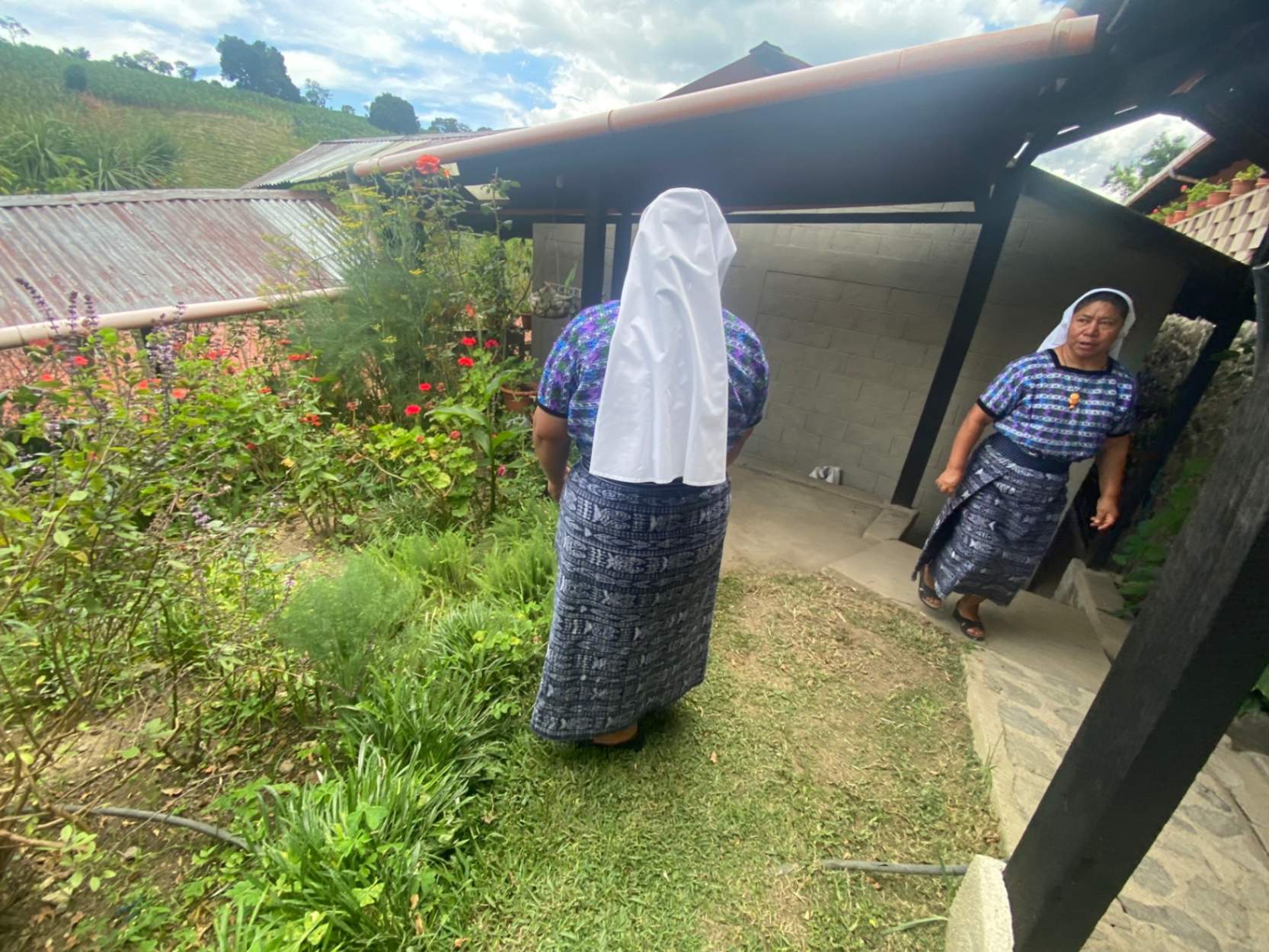 Sr. Angelina Chex, right, talks with Mother Marta Yach Cosme, in the garden of the motherhouse of the Missionary Sisters of the Eucharist in San Andres Semetabaj, Guatemala, Aug. 22, 2023. The community of 49 sisters working in Indigenous communities was founded by U.S. Sr. Tonia Orland of the Sisters of the Presentation of the Blessed Virgin Mary. (GSR photo/Rhina Guidos)