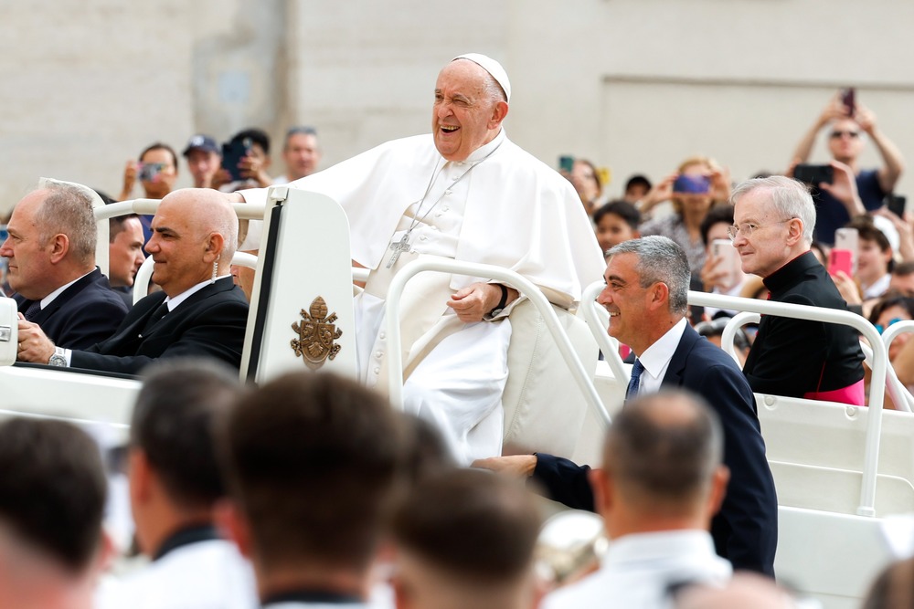 Pope Francis sits in Popemobile