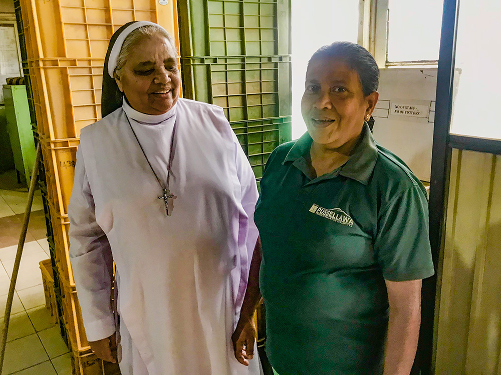 Apostolic Carmel Sr. Maria Amali visits a worker at a tea factory. (Thomas Scaria)