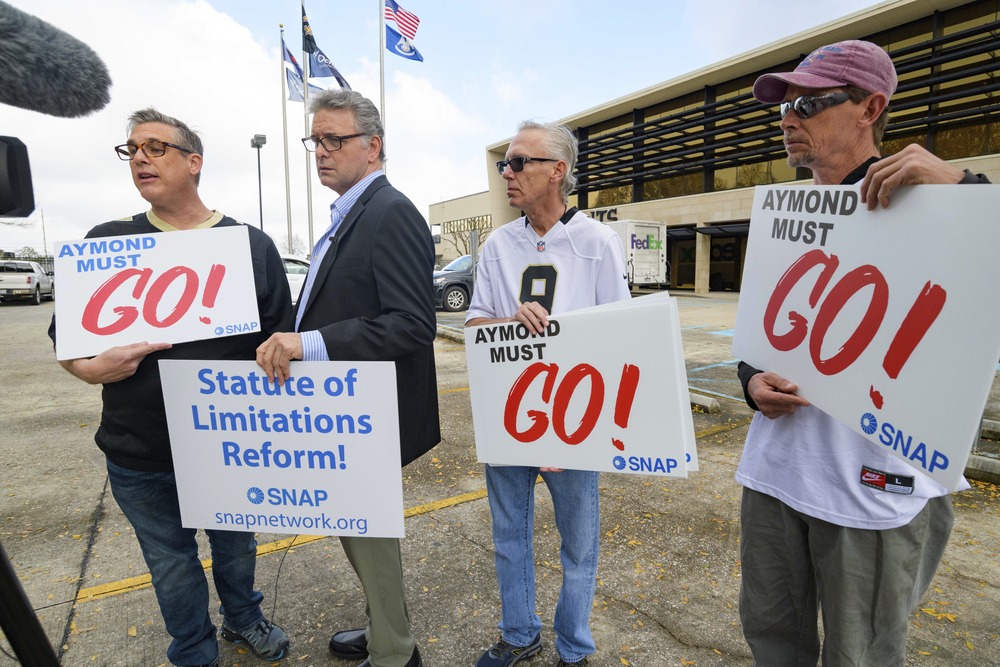 Louisiana Supreme Court statute of limitations People stand holding signs advocating for statute of limitations reforms