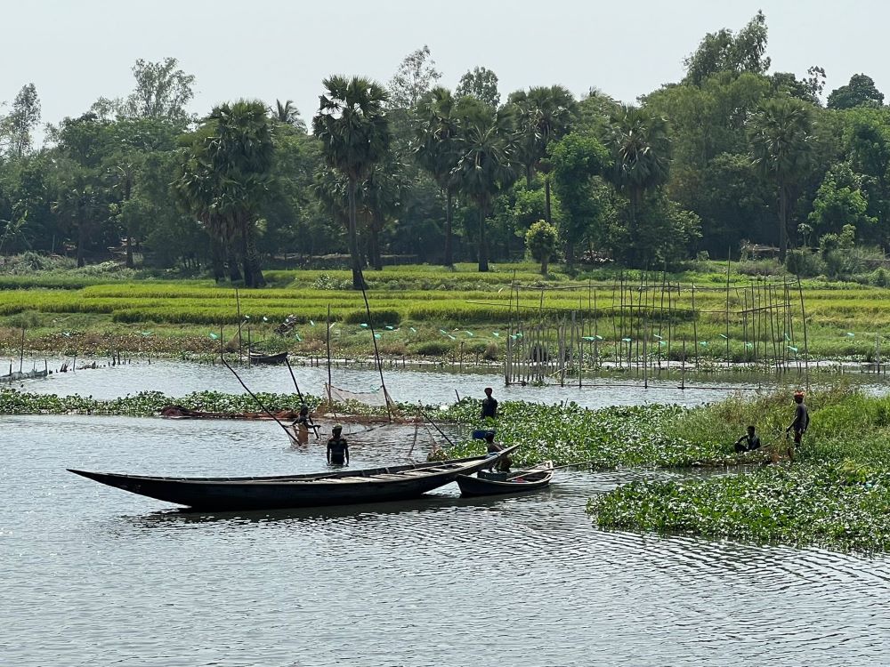 Fishermen work in a marsh a few hundred feet from where Akhter lives in Savar. (Grist/Mahadi Al Hasnat)