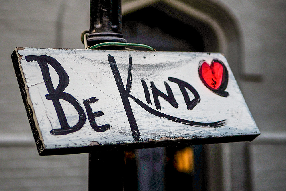 Painted sign that says, "Be Kind" (Unsplash/Adam Nemeroff)