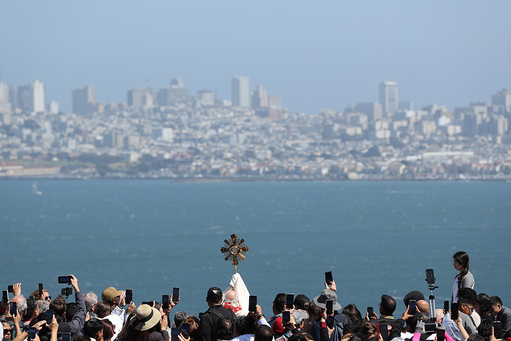 San Francisco Archbishop Salvatore Cordileone elevates the monstrance as he blesses the city and pilgrims after crossing the Golden Gate Bridge in San Francisco May 19. The event began the western route of the National Eucharistic Pilgrimage. (OSV News/Bob Roller)