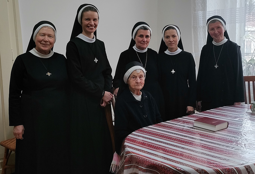 Sr. Olha Ladzhun, seated, is pictured with members of the Basilian community in Khust, Ukraine, along with members of the general leadership team in January 2024. (Courtesy of Emanujila Vishka)