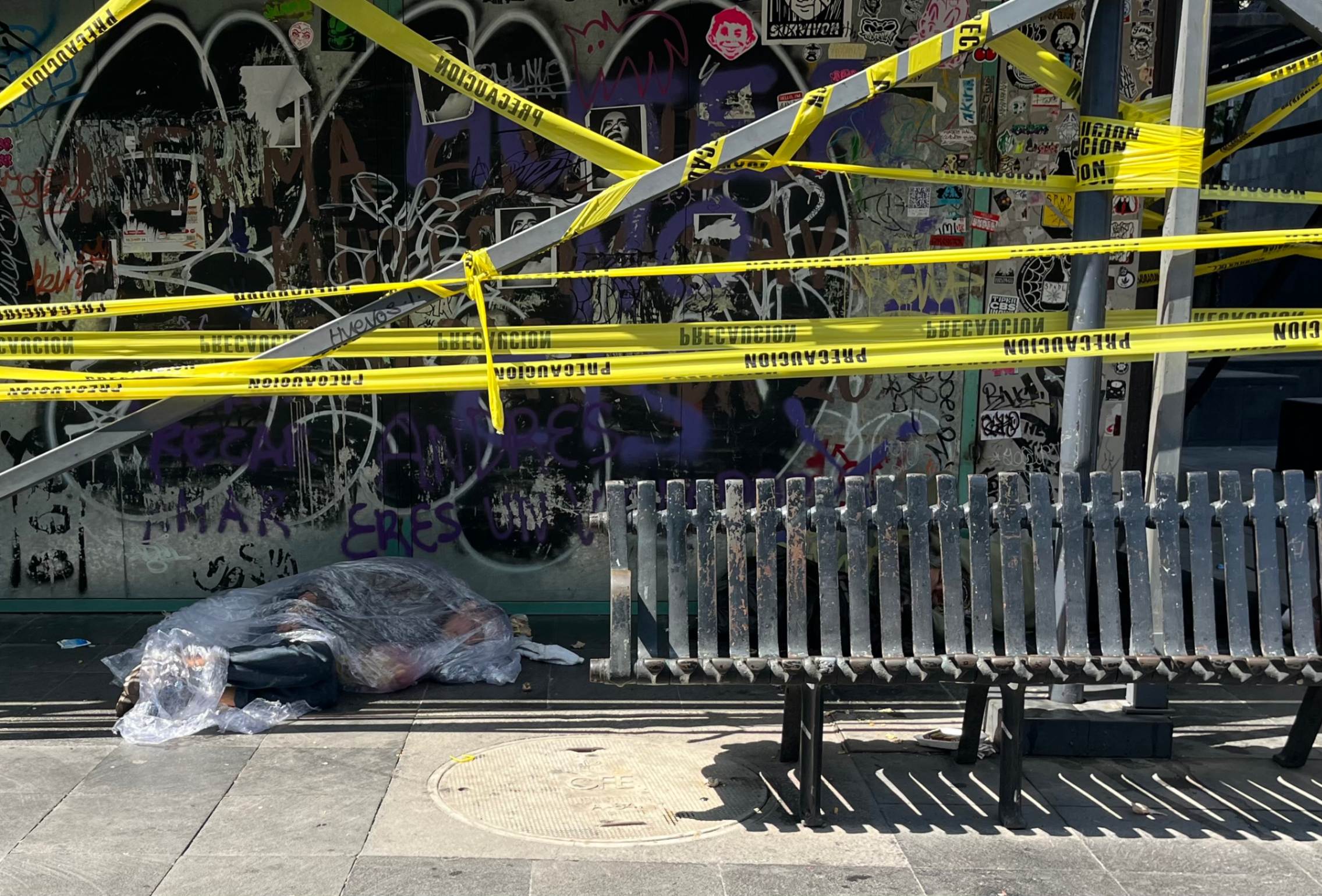 In the downtown area of Mexico City, a man is seen wrapped in a plastic blanket. Josephine Sr. María Magdalena Silva Rentería said the lack of attention from authorities to address the migration crisis is causing hundreds of migrants to live in street conditions and uncertainty. (Luis Donaldo González)