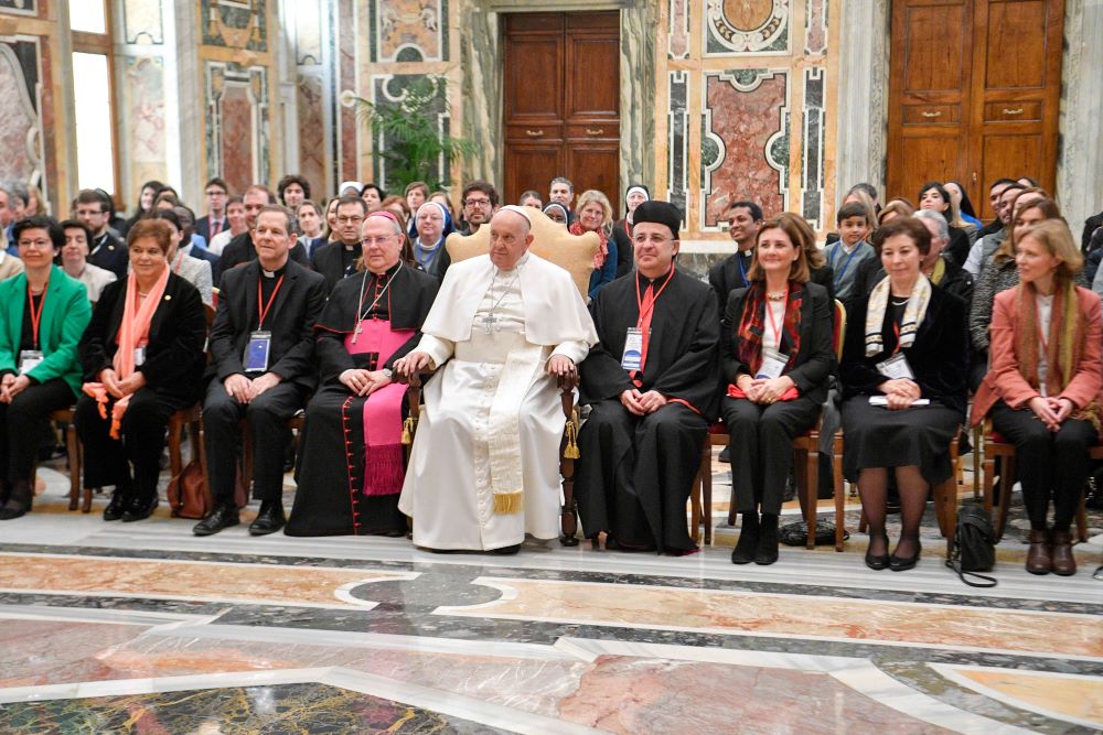 Pope Francis poses for a photo with people attending a two-day conference in Rome on "Women in the Church: Builders of Humanity" during an audience at the Vatican, March 7. 