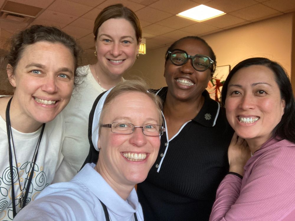 Sr. Kathryn Press, center, poses with current and previous members of the Giving Voice Core Team. They are, from left, Srs. Melissa Camardo, Erin McDonald, Chioma Ahanihu and Thuy Tran. (Kathryn Press)