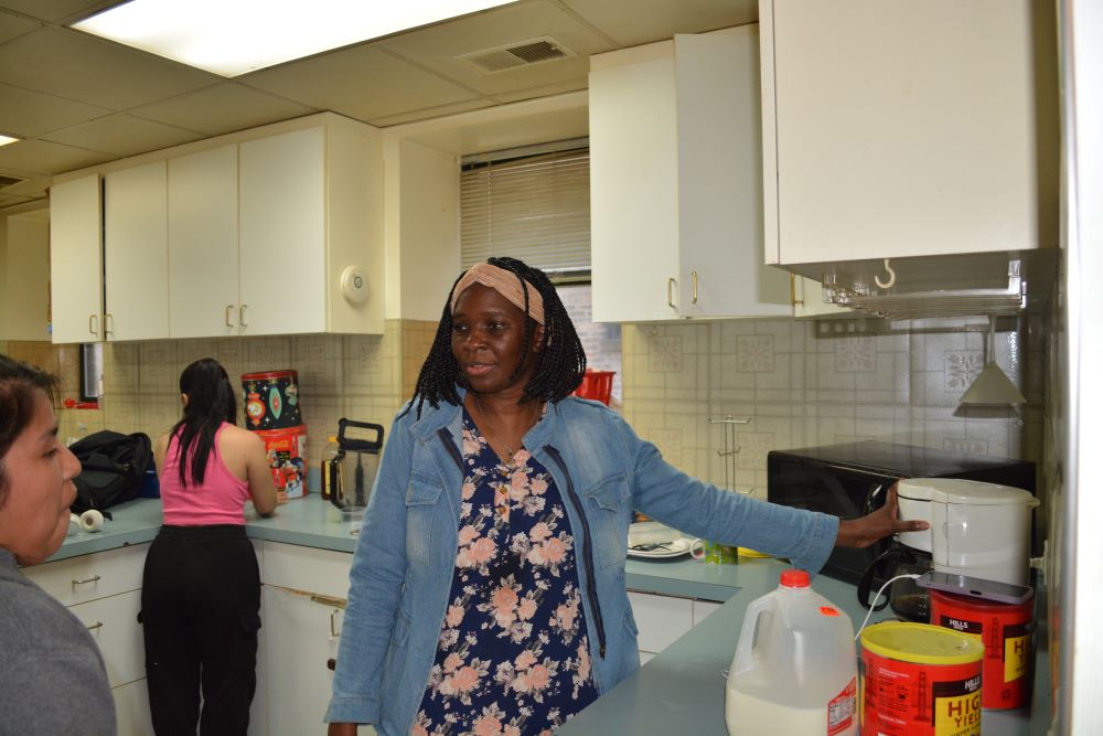 Franciscana Clarisa Sr. Stella Akello, intake officer at Bethany House of Hospitality in Chicago, gives a newly arrived Guatemalan woman a lesson in using the coffeemaker May 7. 