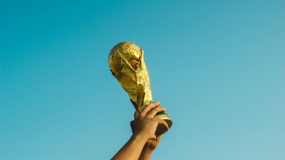 hands holding up a gold trophy