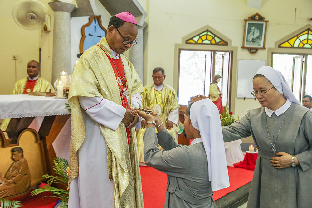 Sr. Teagon Andre Maria kneels in front of Bishop Paul Ponen Kubi during her vows as a Sister of Charity of St. Vincent de Paul June 24 at St. Patrick's Cathedral Church in Mymensingh, Bangladesh. (GSR photo/Stephan Uttom Rozario)