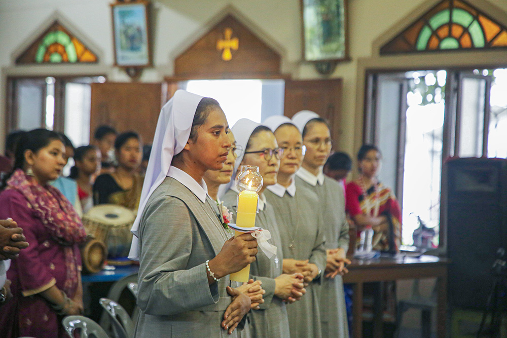 Sr. Teagon Andre Maria holds a candle during Mass at St. Patrick's Cathedral Church in Mymensingh, Bangladesh, on June 24. (GSR photo/Stephan Uttom Rozario)